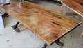 Pecan wood dining table with natural live edge slab top finished in Jacobean stain, handcrafted by Coleto Creek Mill & Design