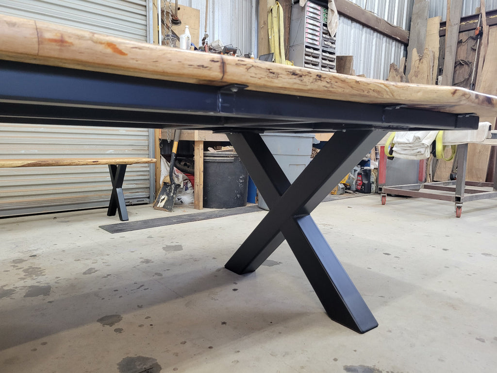 A large live-edge Pecan dining table with matching bench seats, in the natural color with x-style black metal legs