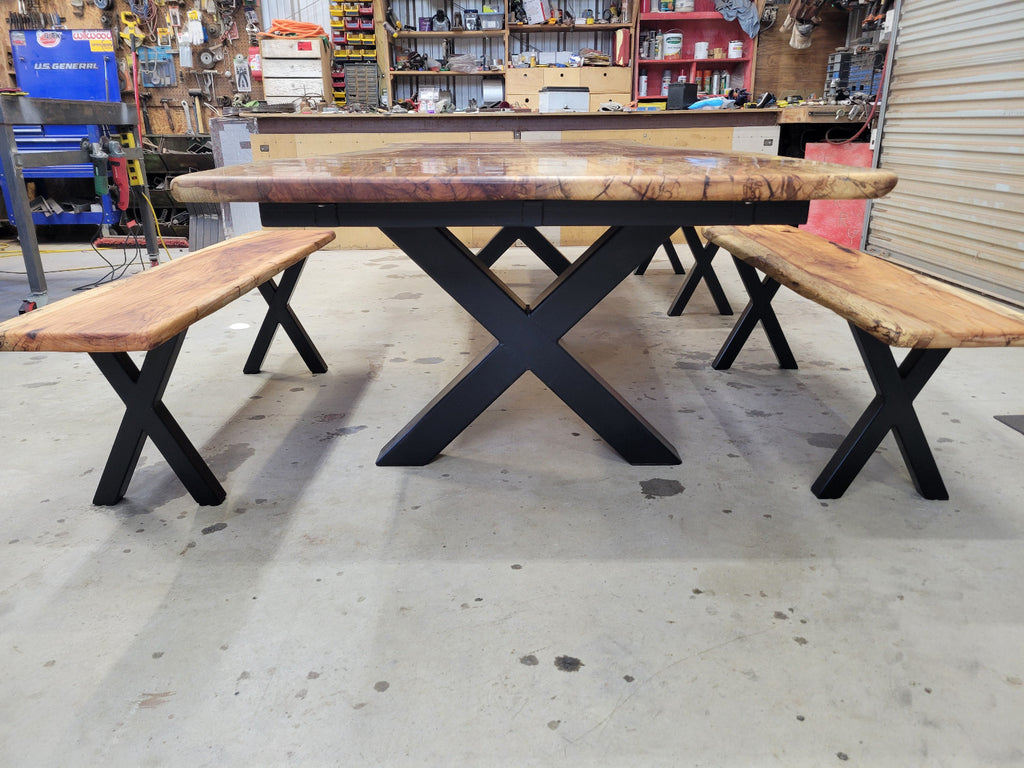 A large live-edge Pecan dining table with matching bench seats, in the natural color with x-style black metal legs
