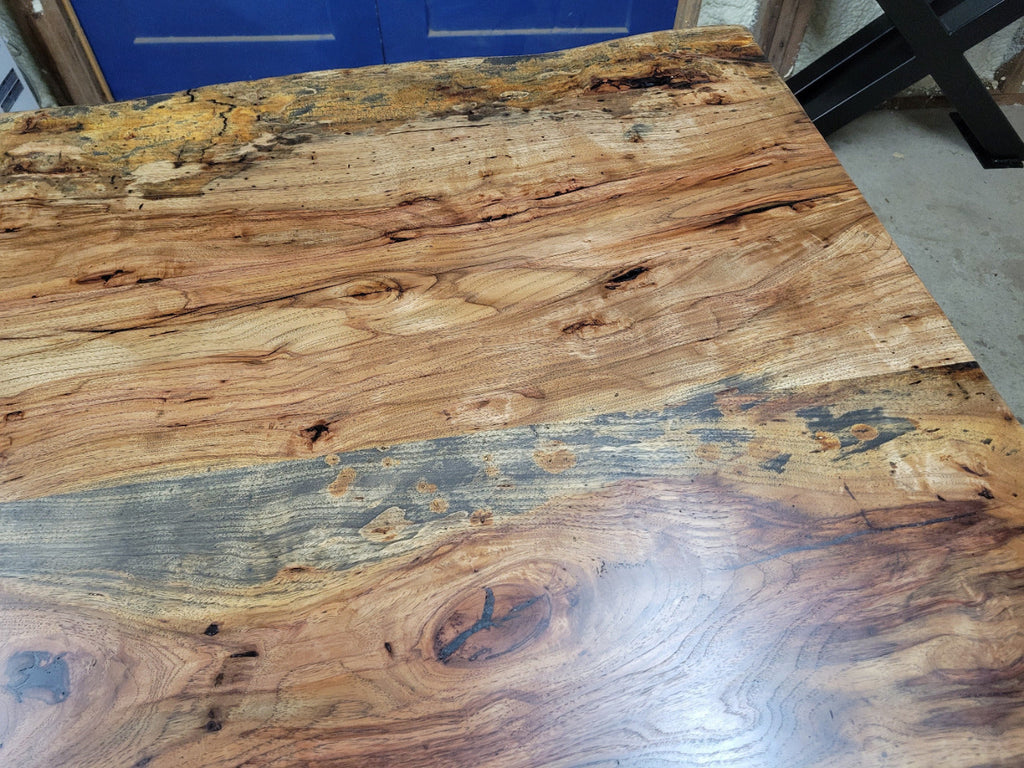 Rustic Pecan Live edge dining table with dark stain and semi-gloss finish.