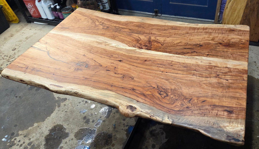 Live edge Pecan Breakfast table with black metal pedestal stand in natural color.