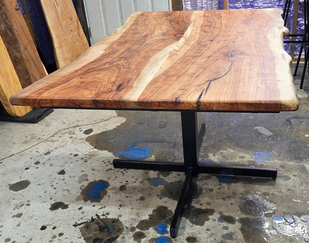 Live edge Pecan Breakfast table with black metal pedestal stand in natural color.