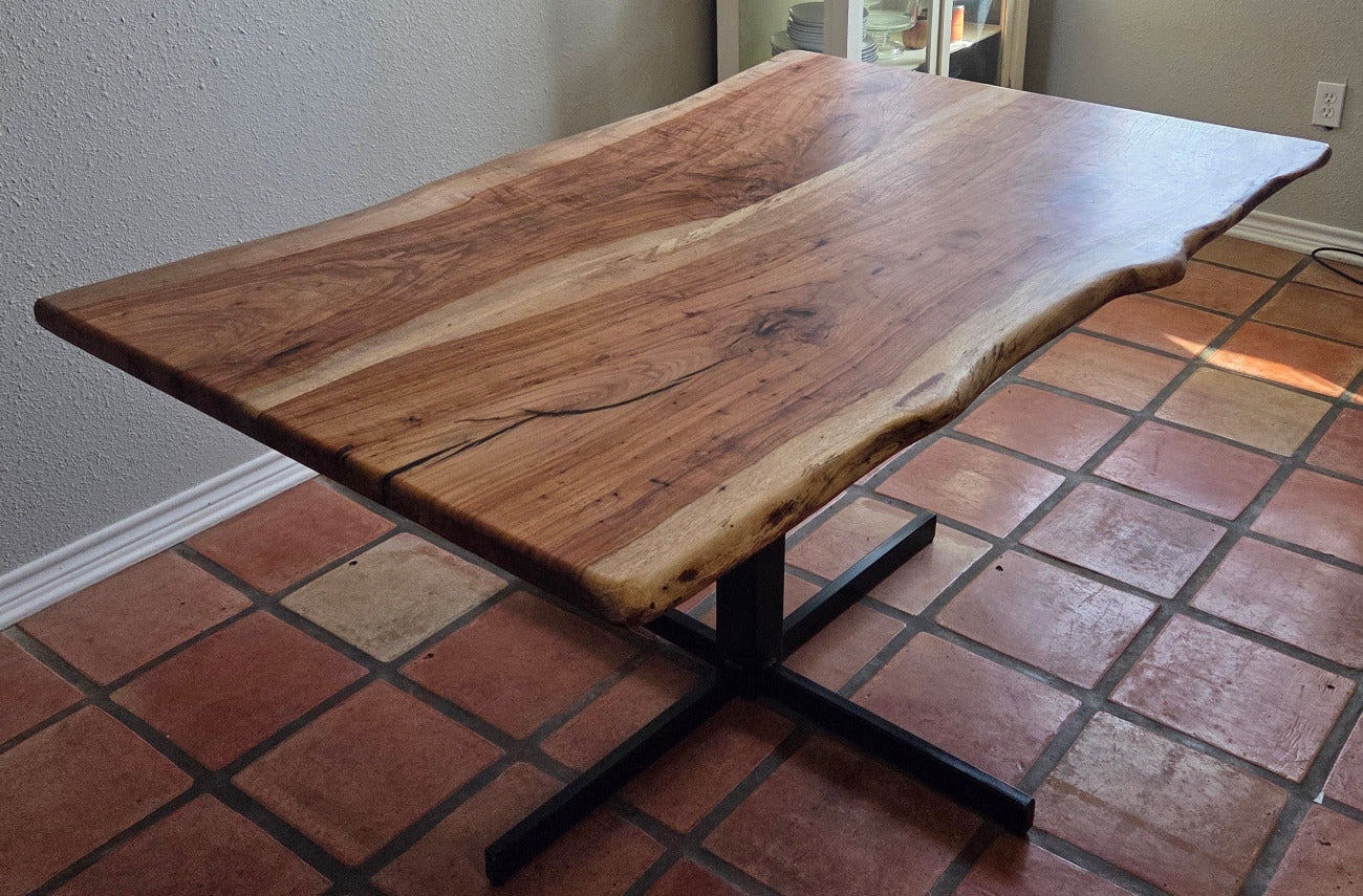 Live edge Pecan Breakfast table with black metal pedestal stand in natural color.