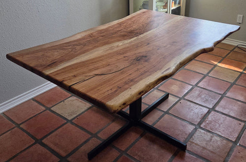 Live edge Pecan Breakfast table with black metal pedestal stand in natural color.