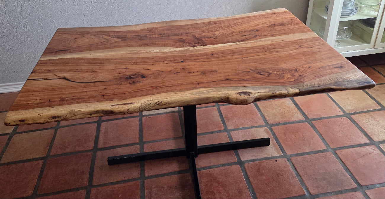Live edge Pecan Breakfast table with black metal pedestal stand in natural color.