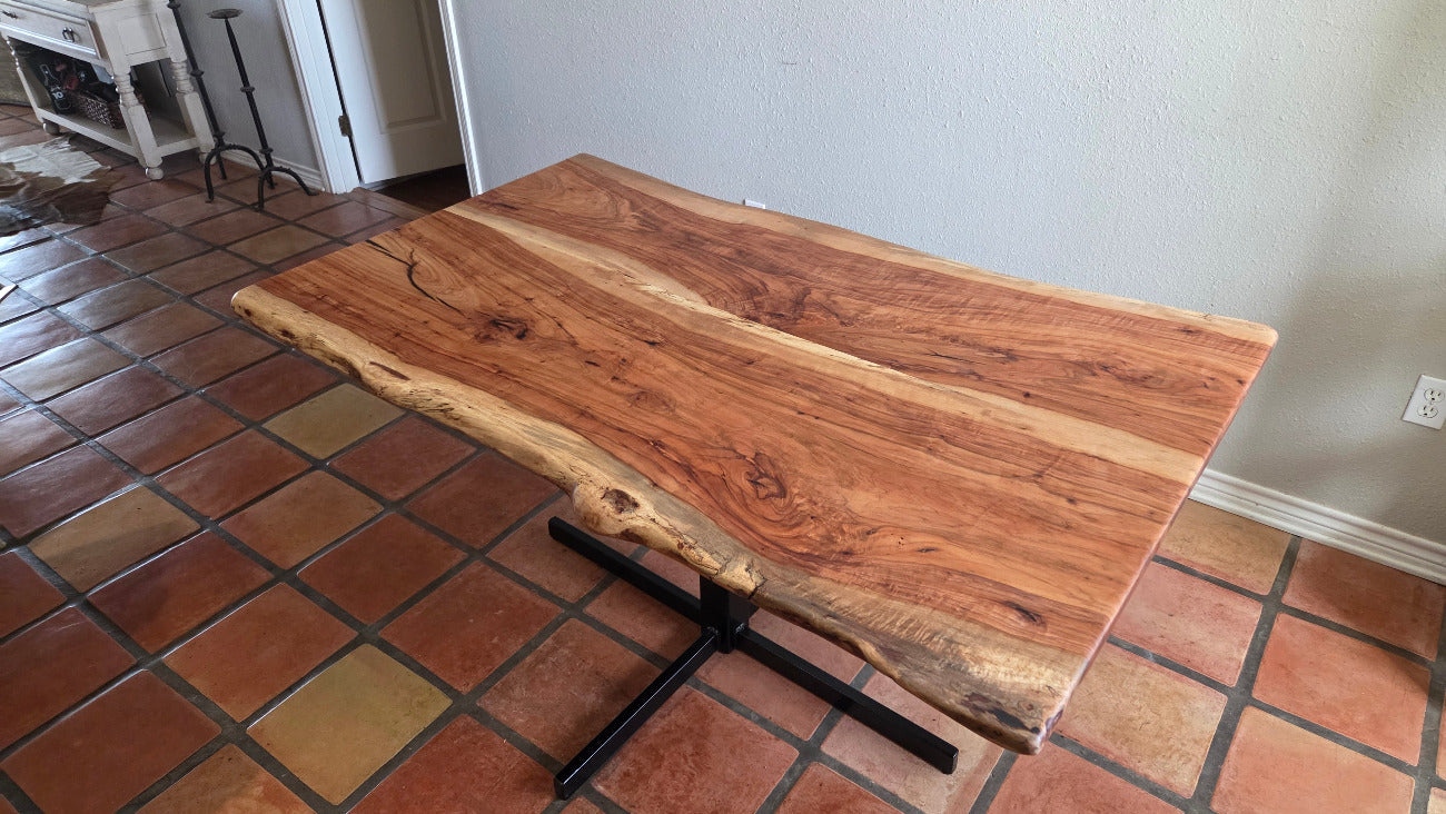 Live edge Pecan Breakfast table with black metal pedestal stand in natural color.