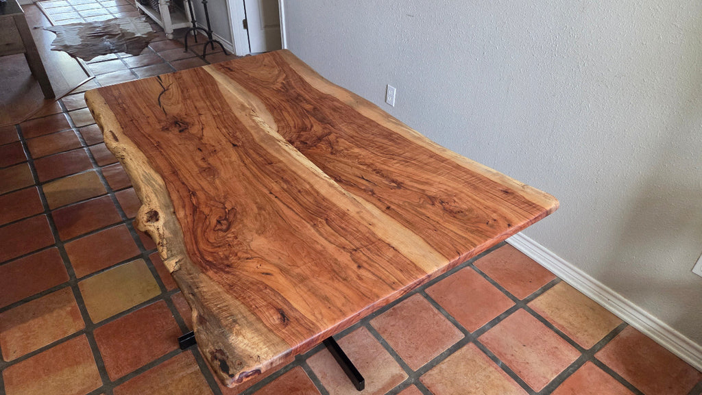 Live edge Pecan Breakfast table with black metal pedestal stand in natural color.