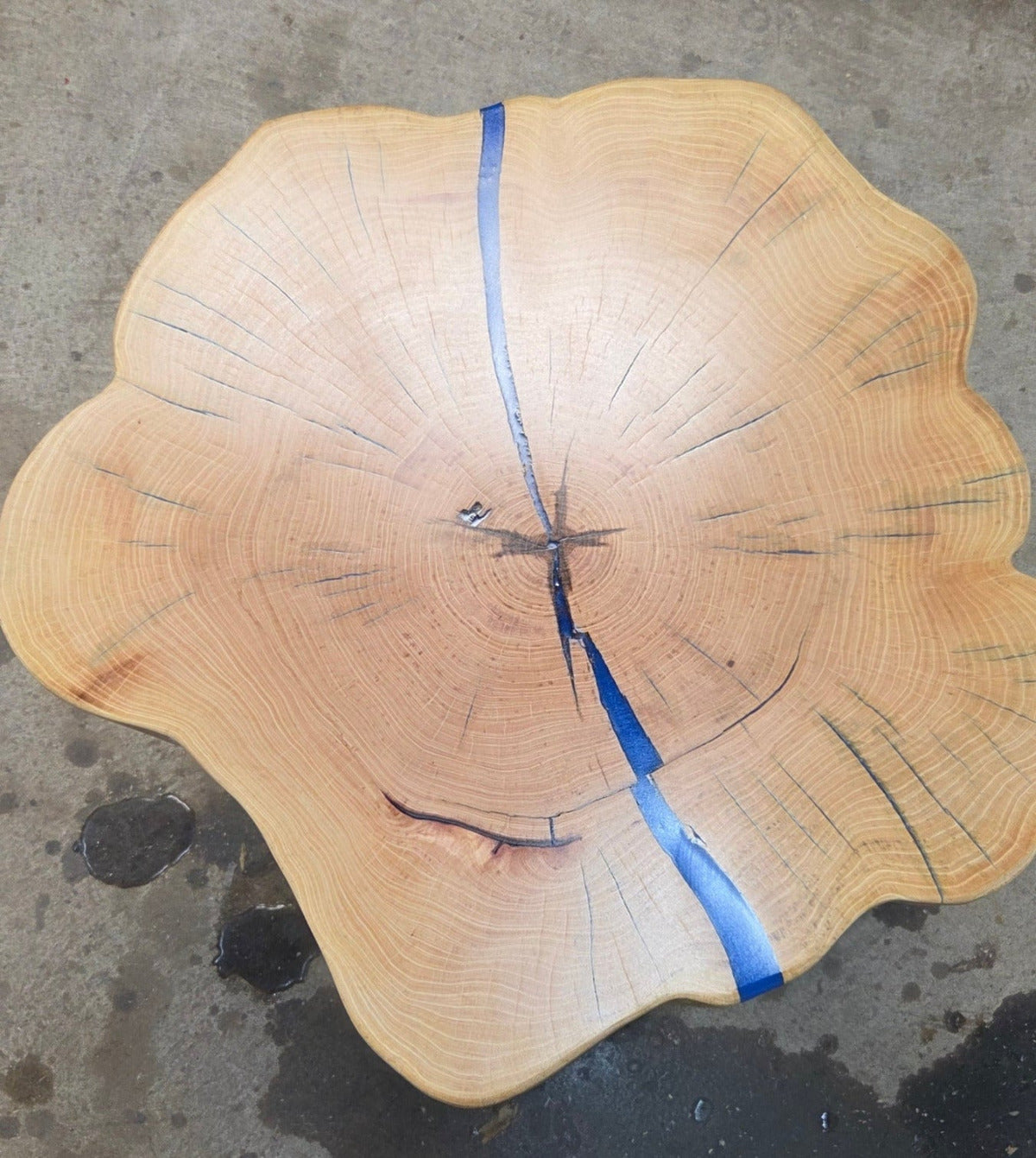 Cedar Elm End Table with Blue Epoxy Fill and black metal legs.