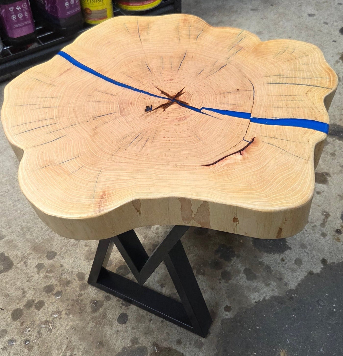 Cedar Elm End Table with Blue Epoxy Fill and black metal legs.