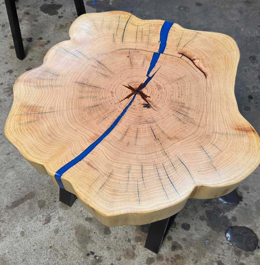 Cedar Elm End Table with Blue Epoxy Fill and black metal legs.