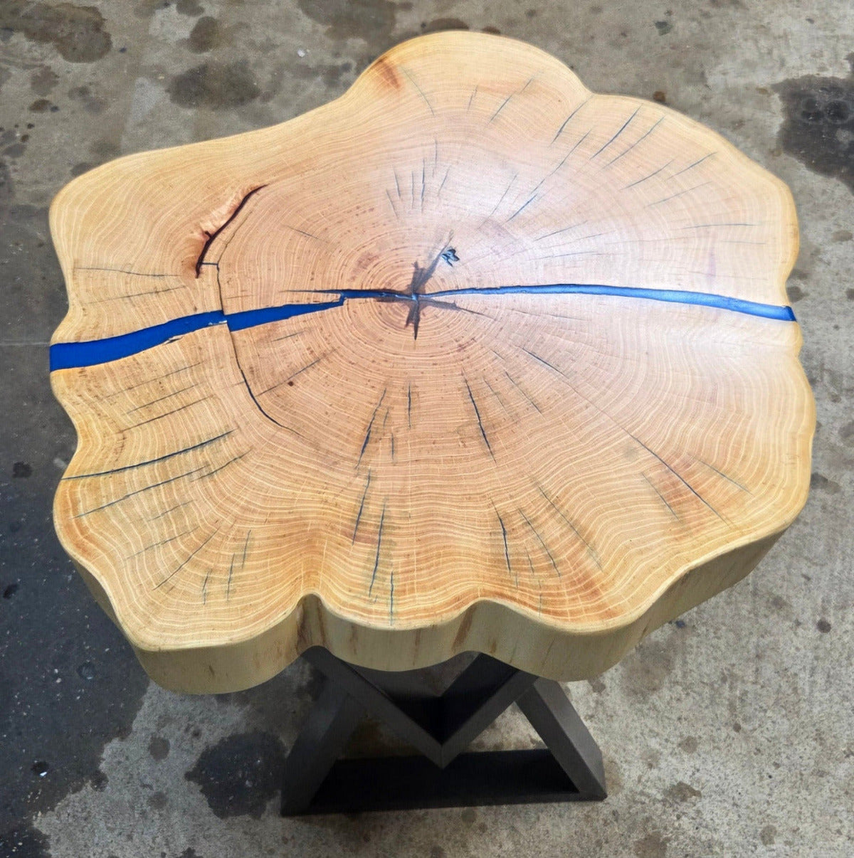 Cedar Elm End Table with Blue Epoxy Fill and black metal legs.