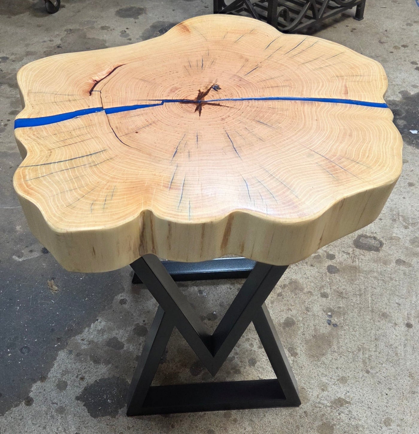 Cedar Elm End Table with Blue Epoxy Fill and black metal legs.