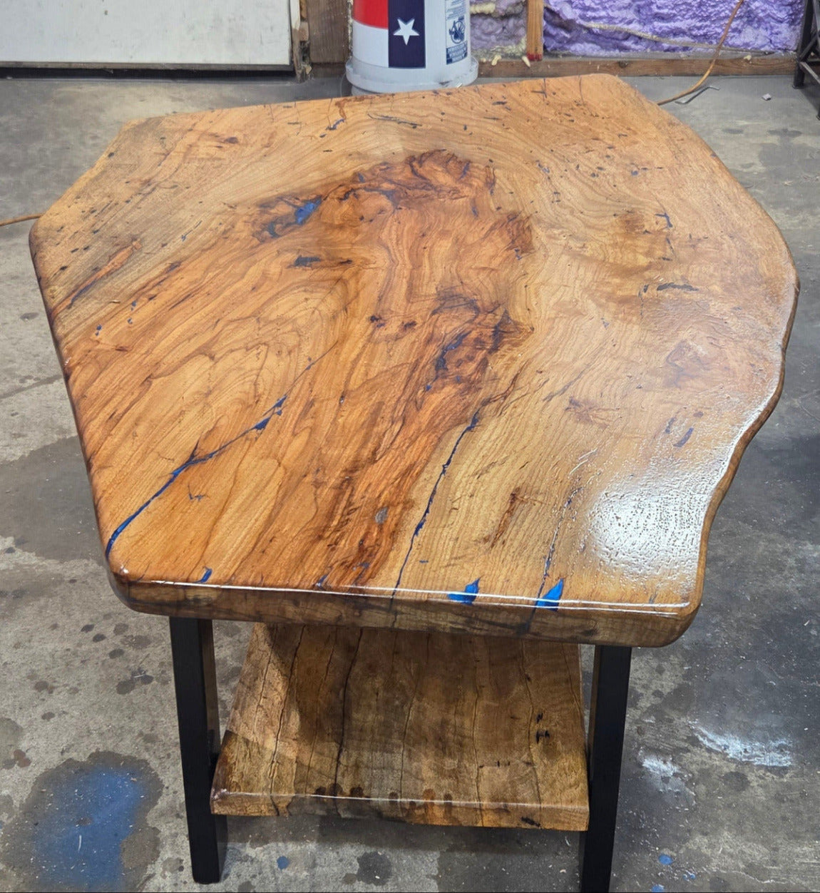 Live edge rustic Rectangular Pecan coffee table with lower shelf on black metal legs, blue epoxy inlay