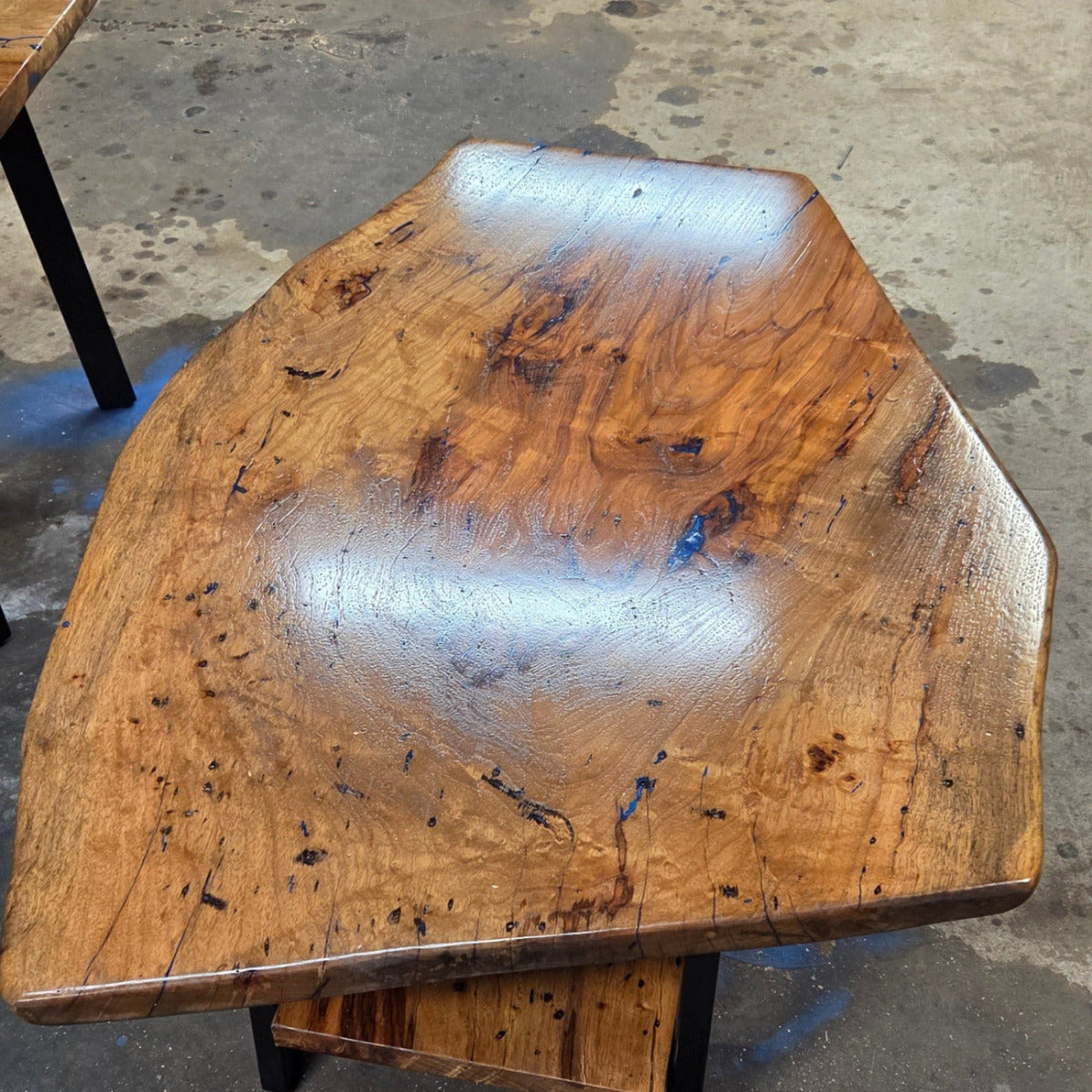 Live edge rustic Rectangular Pecan coffee table with lower shelf on black metal legs, blue epoxy inlay