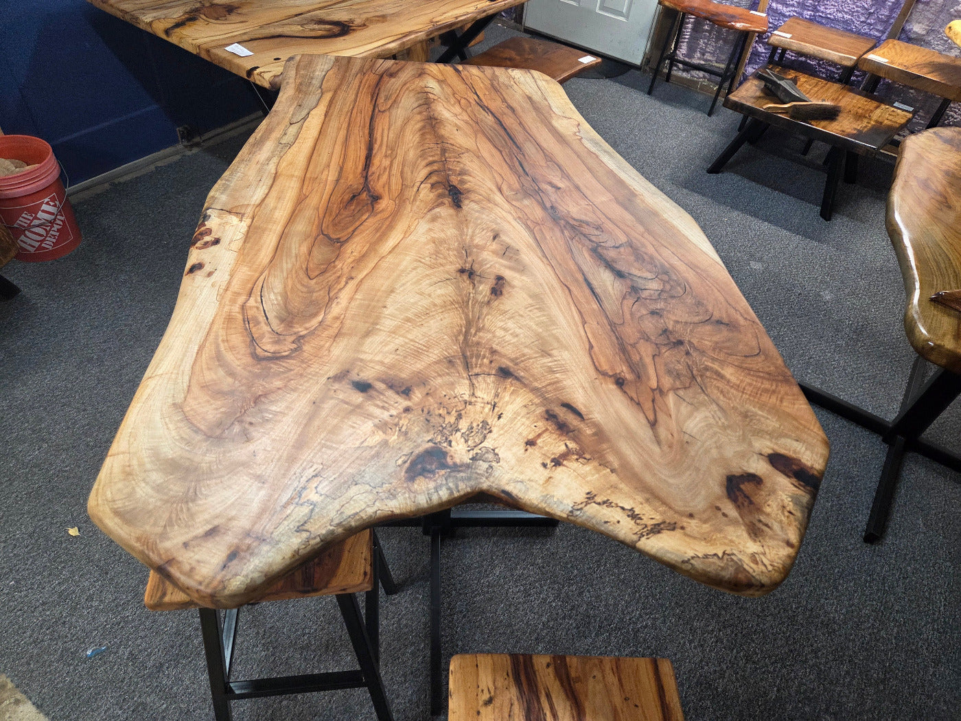 Live edge Burl Pecan Breakfast table with black metal pedestal legs and four matching pecan bar stools