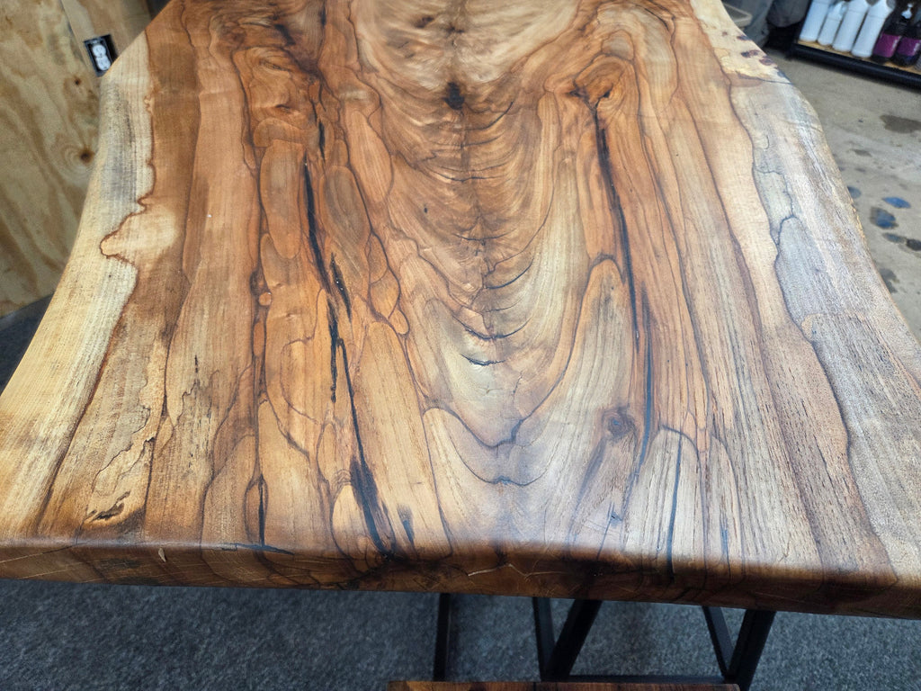 Live edge Burl Pecan Breakfast table with black metal pedestal legs and four matching pecan bar stools