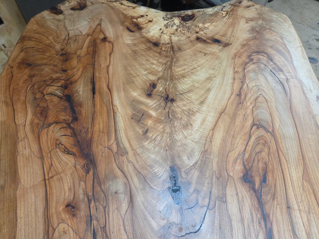 Live edge Burl Pecan Breakfast table with black metal pedestal legs and four matching pecan bar stools