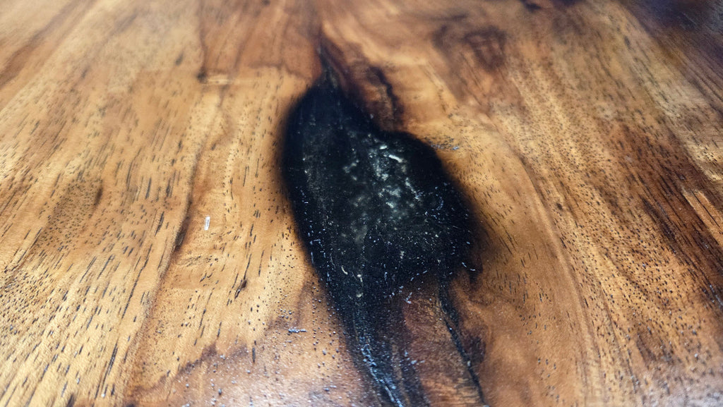 Pecan coffee table with a rustic finish and sho sugi bon treatment with black metal legs