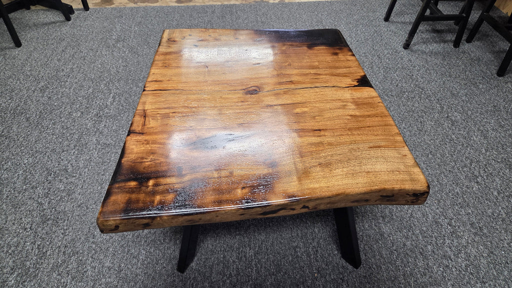 Pecan coffee table with a rustic finish and sho sugi bon treatment with black metal legs