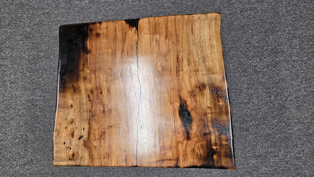 Pecan coffee table with a rustic finish and sho sugi bon treatment with black metal legs