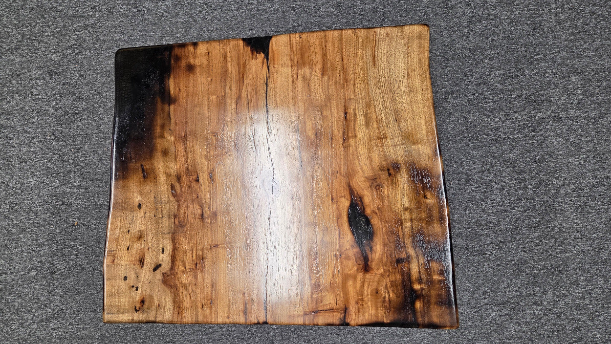 Pecan coffee table with a rustic finish and sho sugi bon treatment with black metal legs