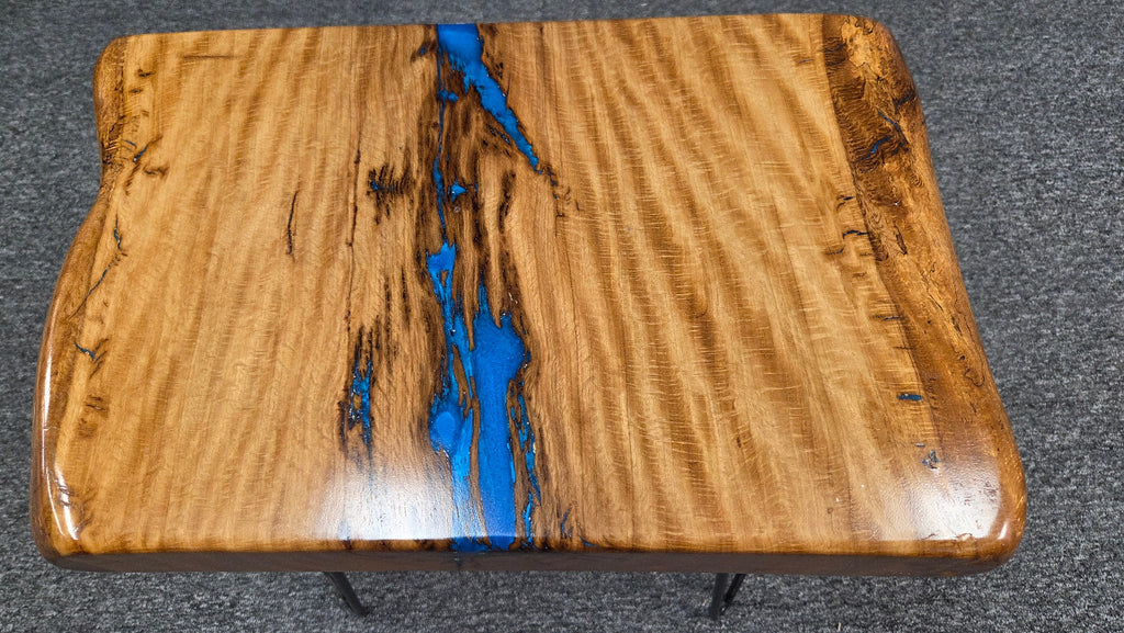 Live oak End table featuring live edge sides with blue epoxy inlay on black hair pin legs