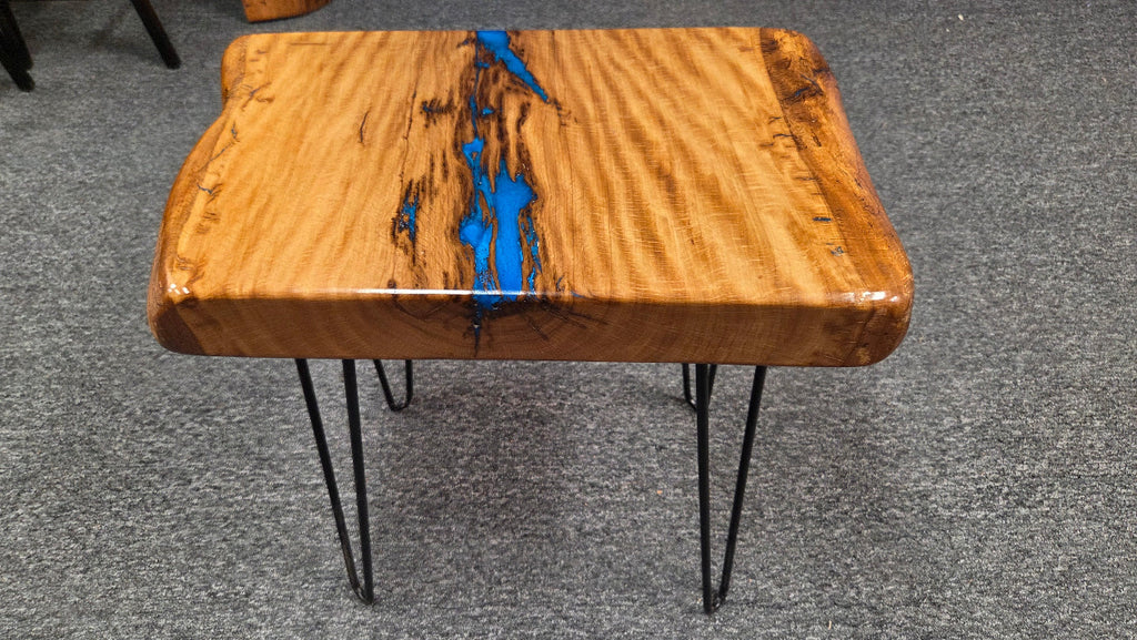 Live oak End table featuring live edge sides with blue epoxy inlay on black hair pin legs