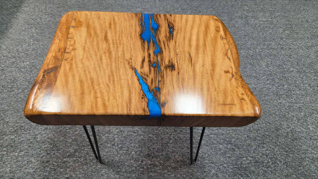 Live oak End table featuring live edge sides with blue epoxy inlay on black hair pin legs