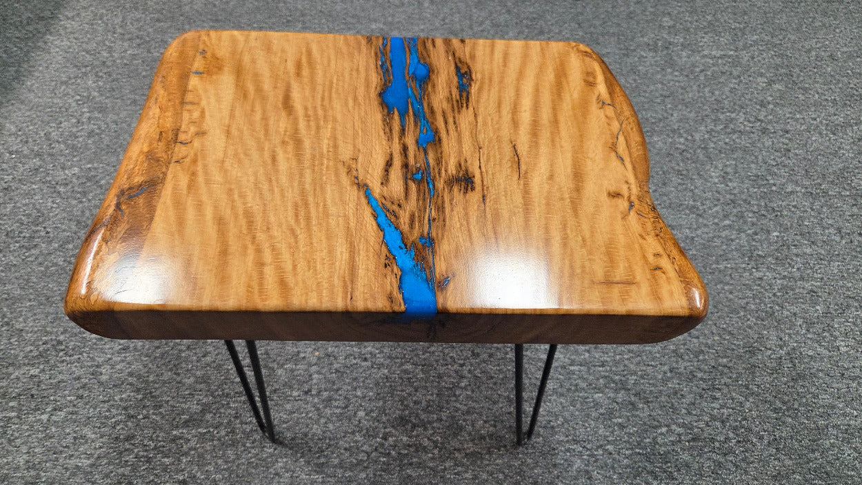 Live oak End table featuring live edge sides with blue epoxy inlay on black hair pin legs
