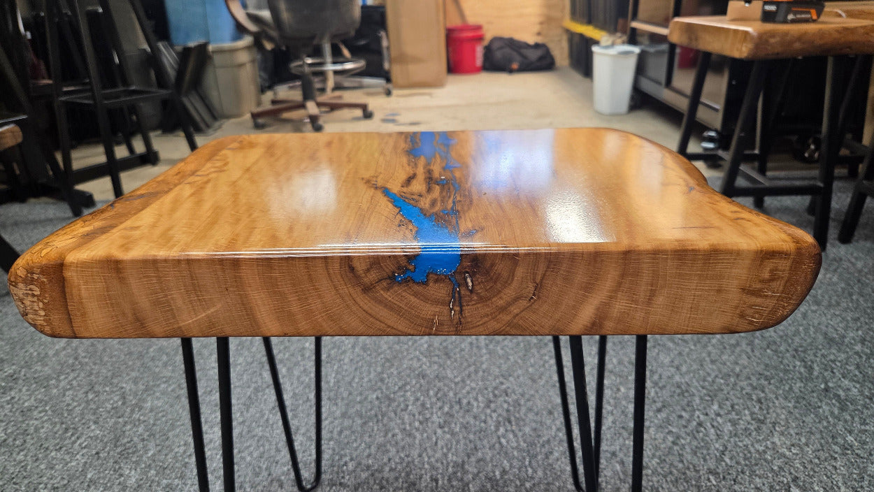 Live oak End table featuring live edge sides with blue epoxy inlay on black hair pin legs