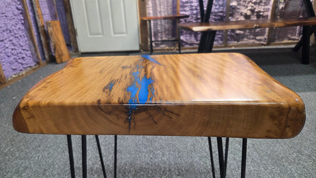 Live oak End table featuring live edge sides with blue epoxy inlay on black hair pin legs