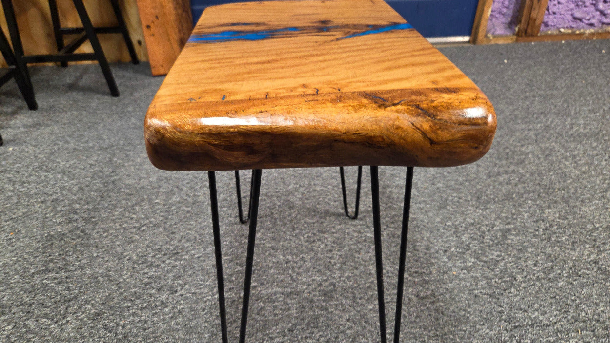 Live oak End table featuring live edge sides with blue epoxy inlay on black hair pin legs