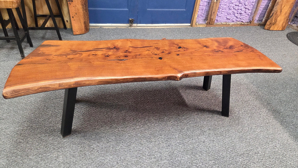 beautiful Bois D'Arc Bench Live edge rustic with black metal legs.