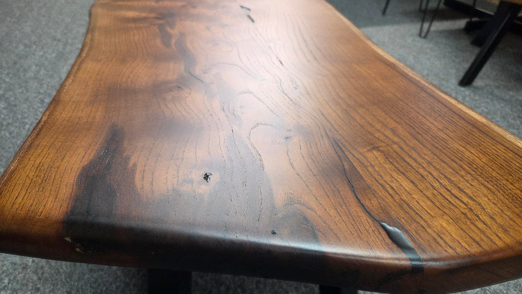 beautiful Bois D'Arc Bench Live edge rustic with black metal legs.