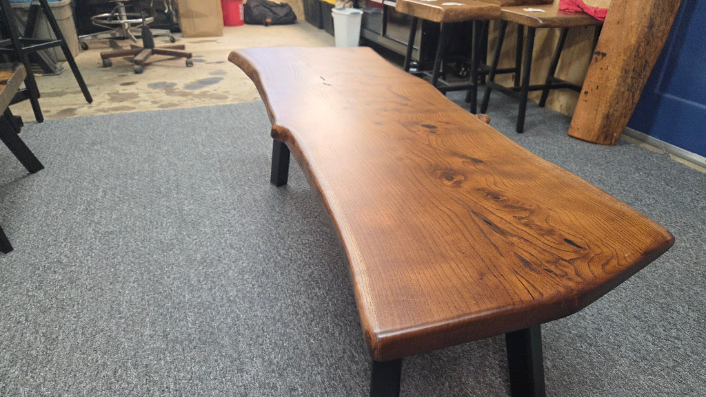 beautiful Bois D'Arc Bench Live edge rustic with black metal legs.