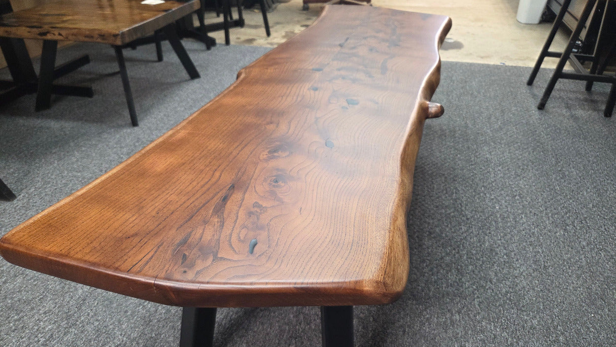 beautiful Bois D'Arc Bench Live edge rustic with black metal legs.