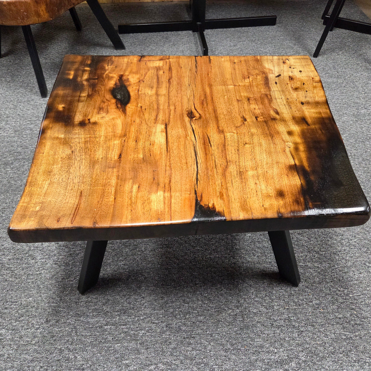 Pecan coffee table with a rustic finish and sho sugi bon treatment with black metal legs