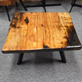 Pecan coffee table with a rustic finish and sho sugi bon treatment with black metal legs