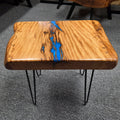 Live oak End table featuring live edge sides with blue epoxy inlay on black hair pin legs