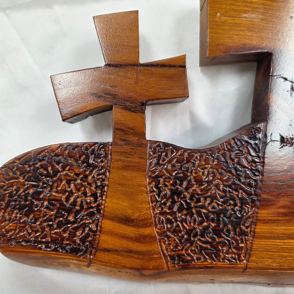 A Bois D'Arc decorative wall plaque featuring three stylized Christian crosses cut from a single slab, hand carved with burned finish sho sugi ban with natural grain 