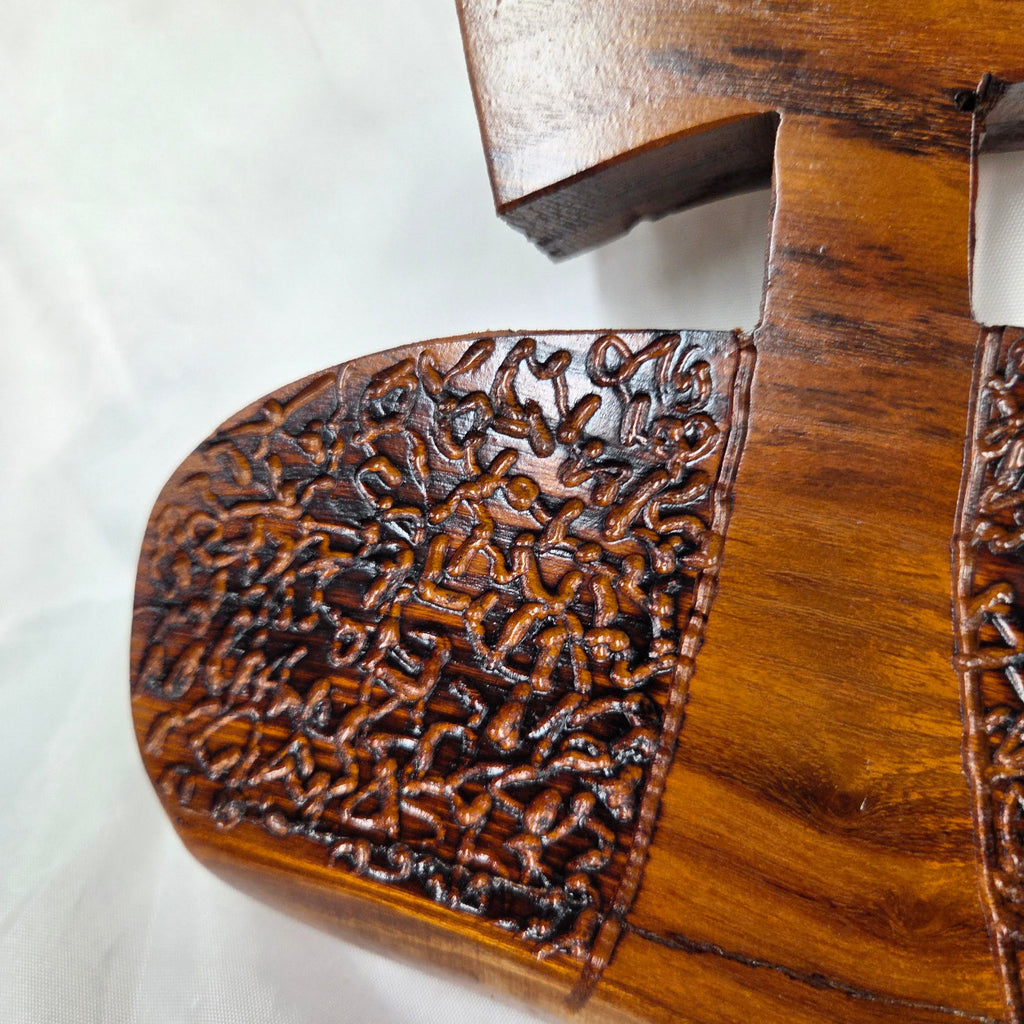 A Bois D'Arc decorative wall plaque featuring three stylized Christian crosses cut from a single slab, hand carved with burned finish sho sugi ban with natural grain 