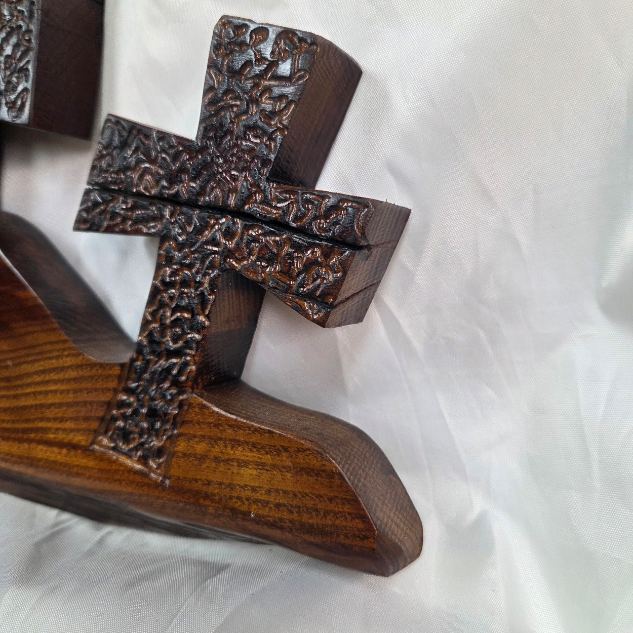 A Bois D'Arc decorative wall plaque featuring three stylized Christian crosses cut from a single slab, hand carved with burned finish sho sugi ban with natural grain 