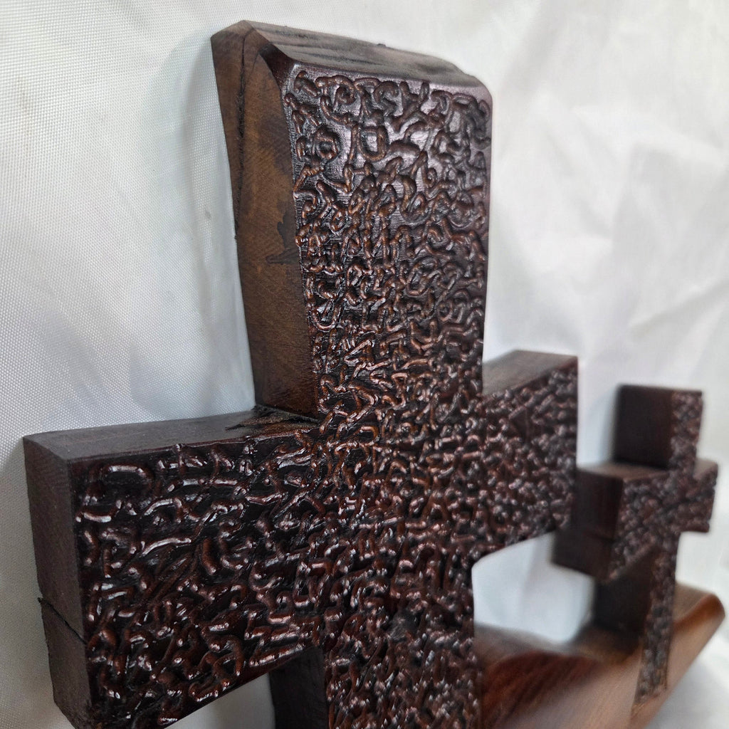 A Bois D'Arc decorative wall plaque featuring three stylized Christian crosses cut from a single slab, hand carved with burned finish sho sugi ban with natural grain 
