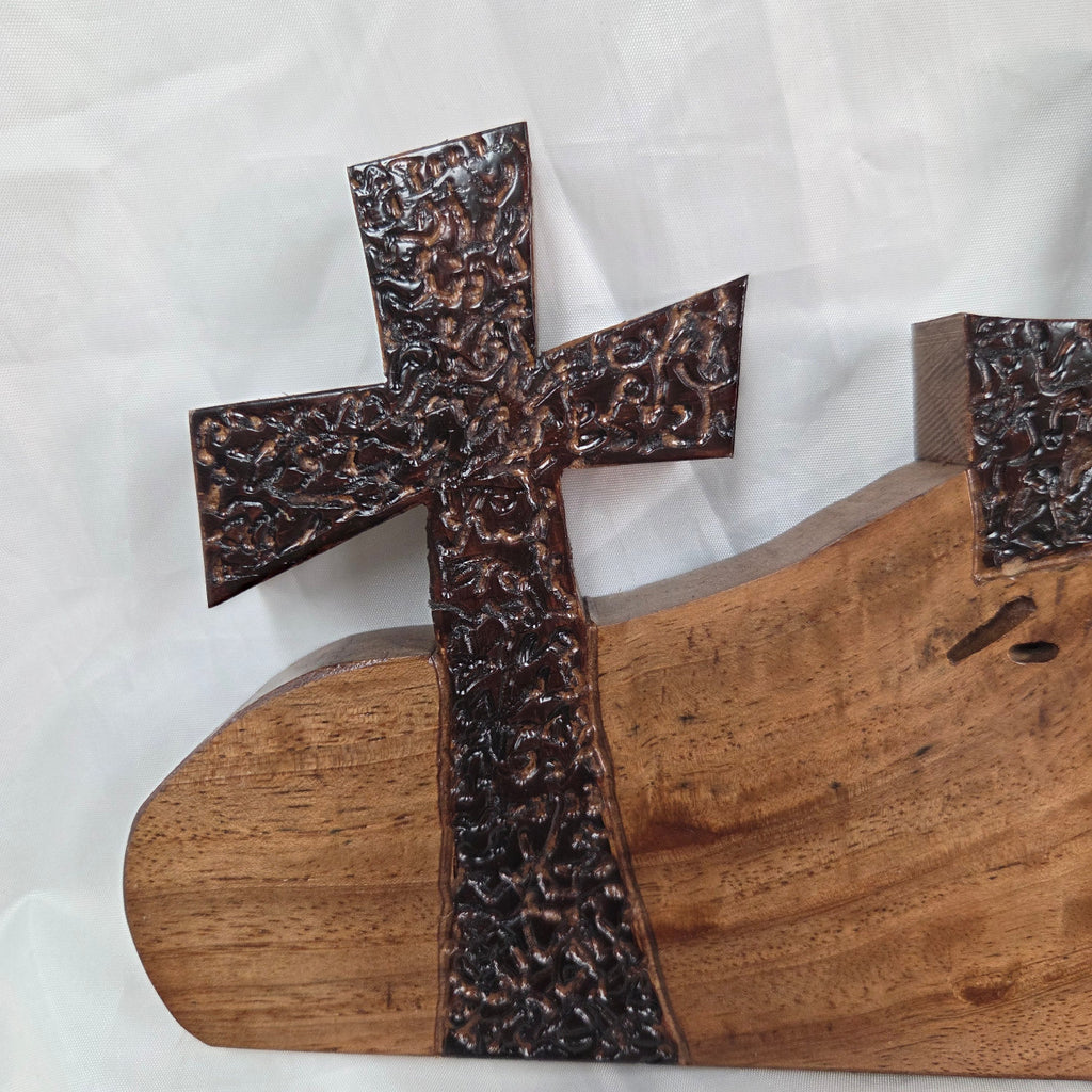 A Pecan decorative wall plaque featuring three stylized Christian crosses cut from a single slab, hand carved with burned finish sho sugi ban with natural grain 