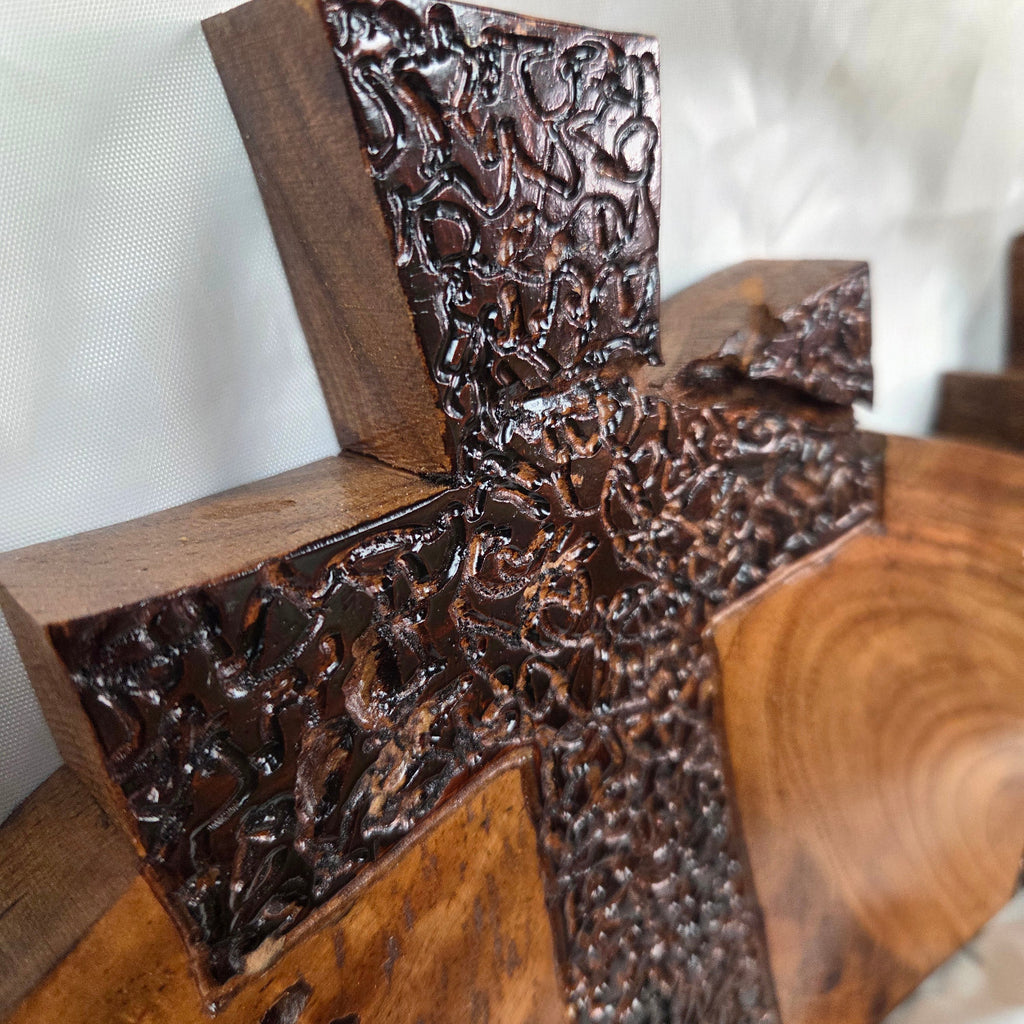 A Pecan decorative wall plaque featuring three stylized Christian crosses cut from a single slab, hand carved with burned finish sho sugi ban with natural grain 
