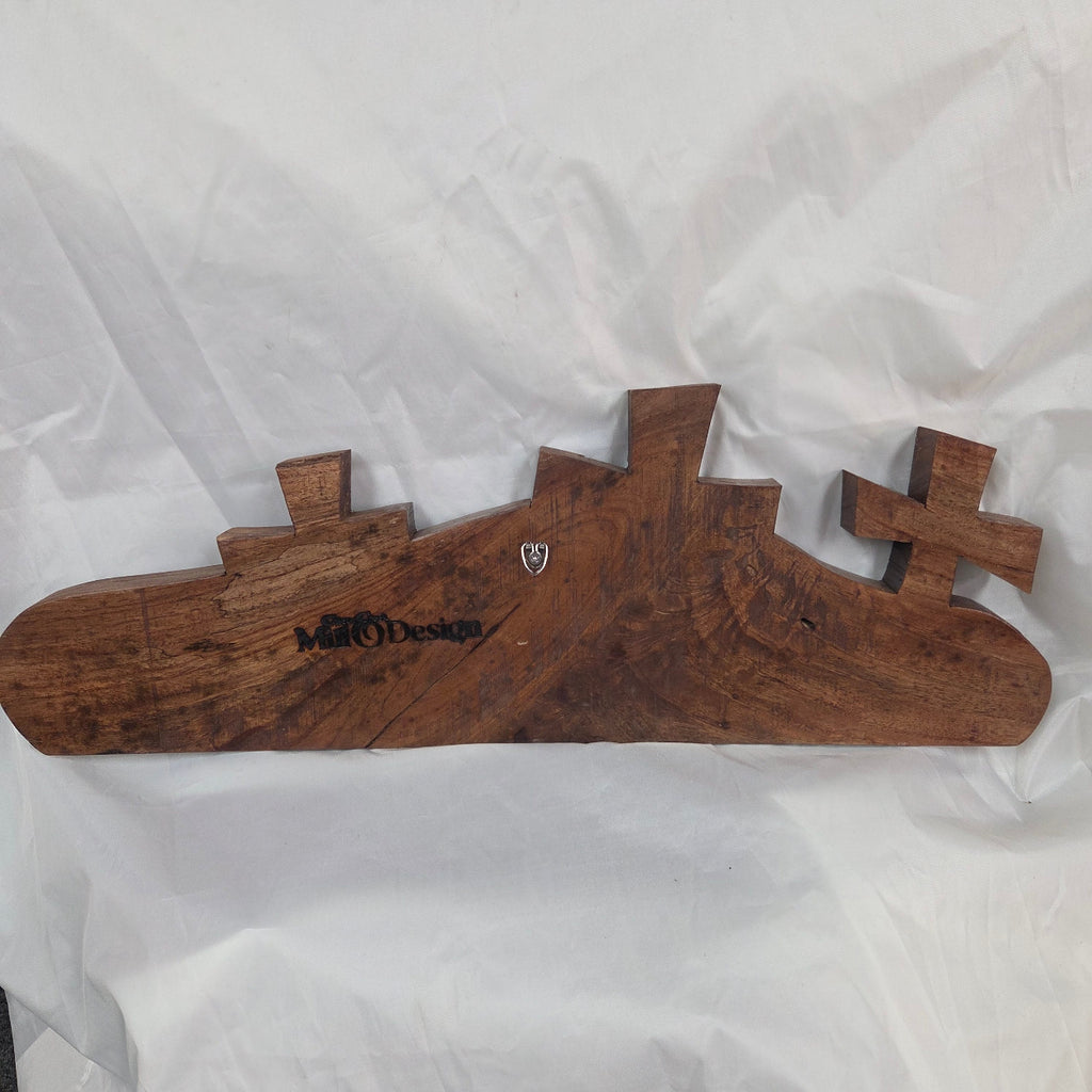 A Pecan decorative wall plaque featuring three stylized Christian crosses cut from a single slab, hand carved with burned finish sho sugi ban with natural grain 
