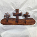 A Bois D'Arc decorative wall plaque featuring three stylized Christian crosses cut from a single slab, hand carved with burned finish sho sugi ban