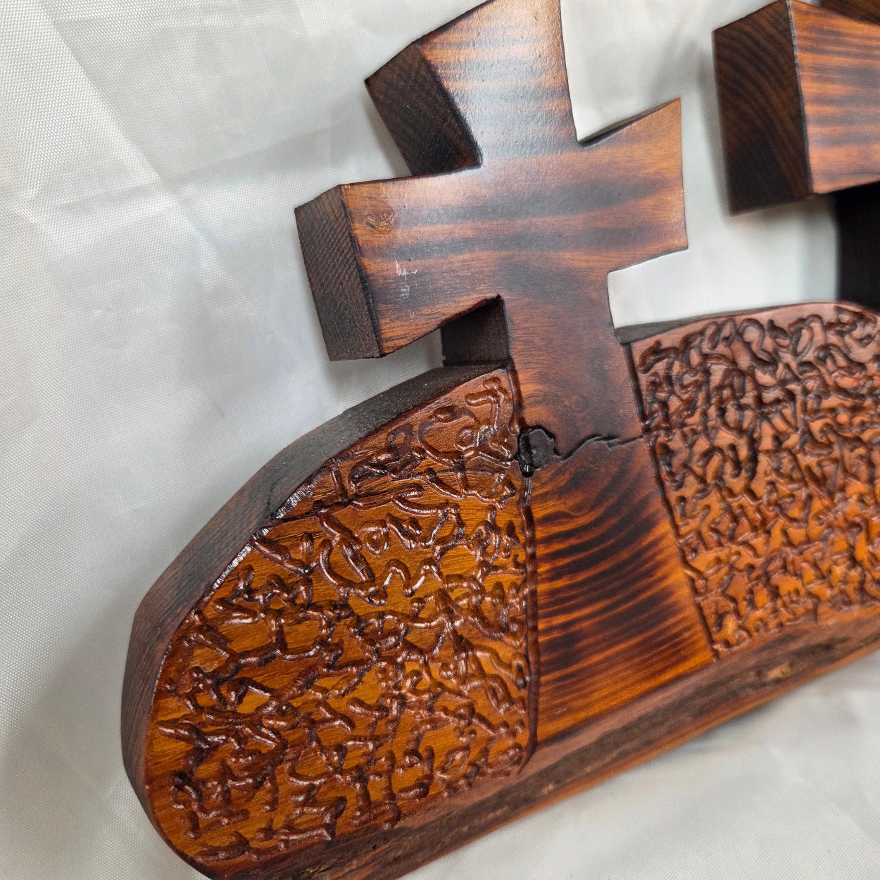 A Bois D'Arc decorative wall plaque featuring three stylized Christian crosses cut from a single slab, hand carved with burned finish sho sugi ban