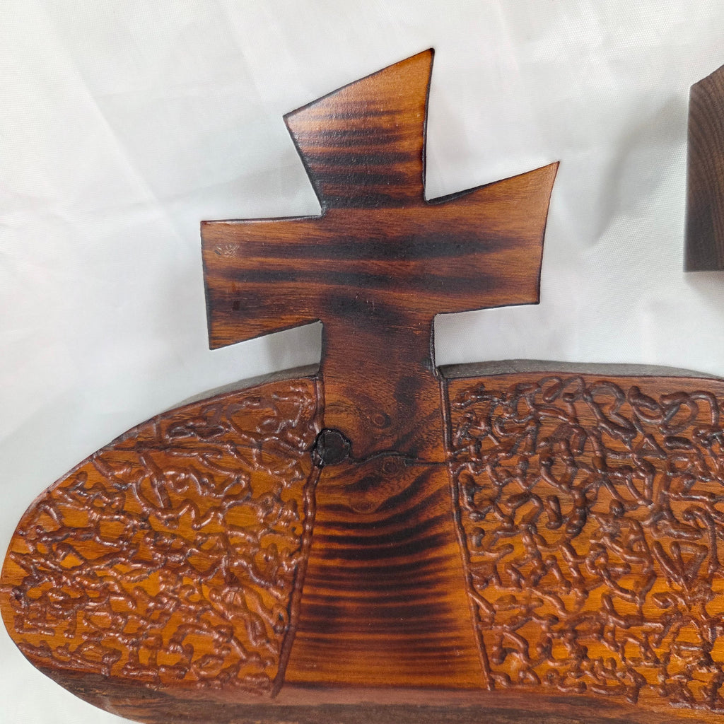 A Bois D'Arc decorative wall plaque featuring three stylized Christian crosses cut from a single slab, hand carved with burned finish sho sugi ban