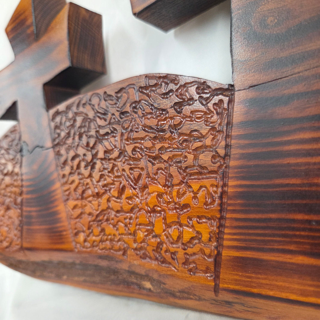 A Bois D'Arc decorative wall plaque featuring three stylized Christian crosses cut from a single slab, hand carved with burned finish sho sugi ban